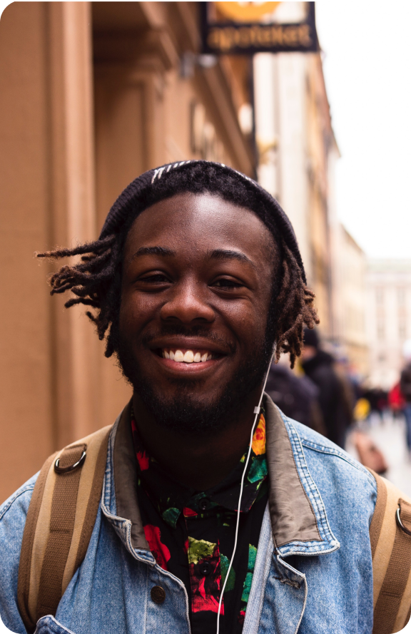 Young man with rasta hair wearing jean top