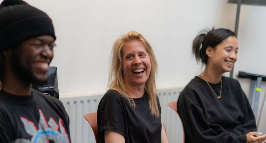 Three people sat in a room looking cheerful