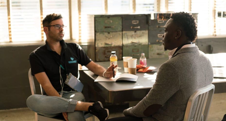 Two people talking across a table