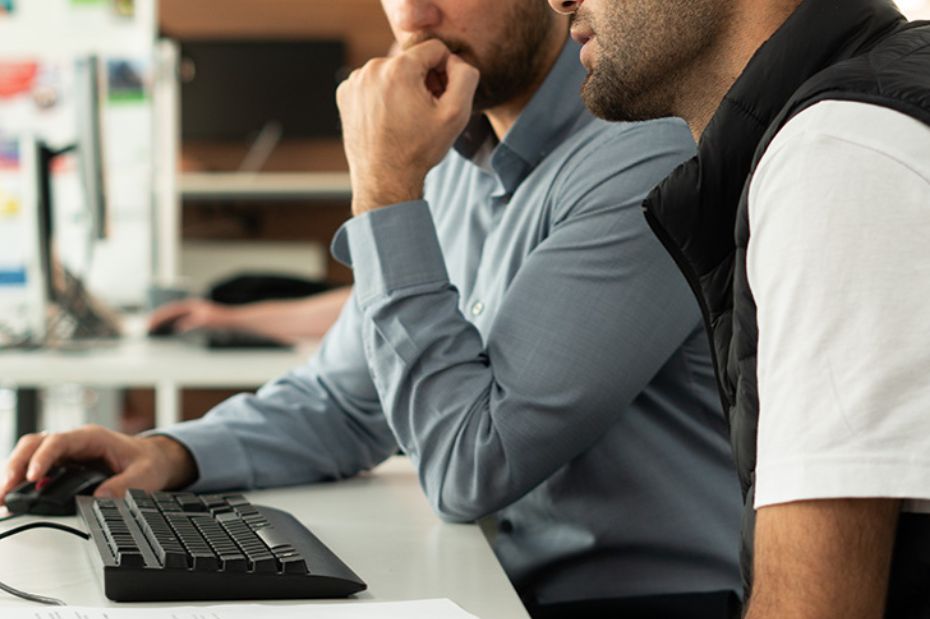 Two men sat at a computer