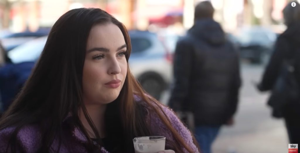 Photo of woman with dark hear looking thoughtful