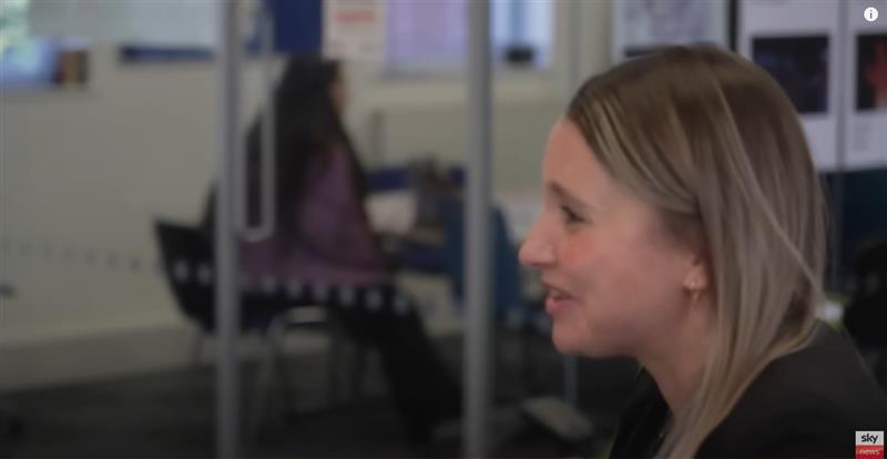 Woman smiling at work coach desk