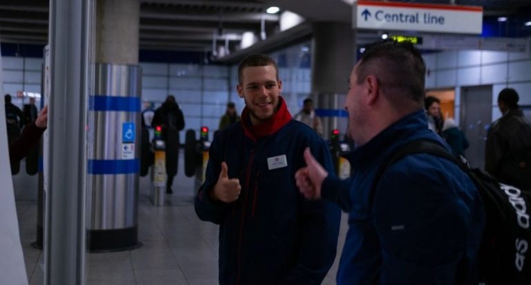 Two men smiling and giving each other a thumbs up.