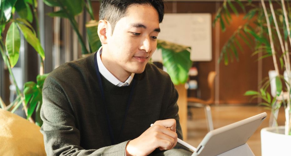 Trusted Assessor Level 2 - Man sat with tablet and using stylus