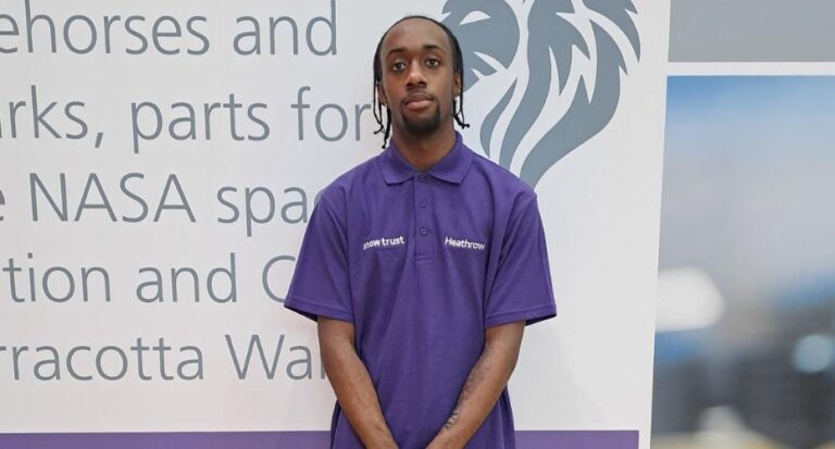 Man standing in front of board wearing a shaw trust top