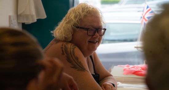 Woman with glasses sat mid conversation