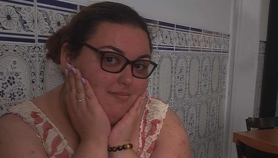 Ema sitting down wearing glasses